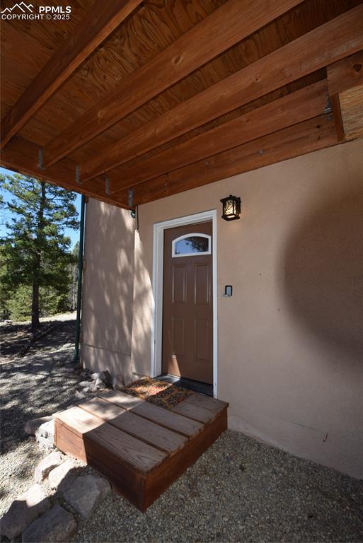 78 Powderhorn Ln, Florissant, CO 80816 - doorway to property featuring stucco siding