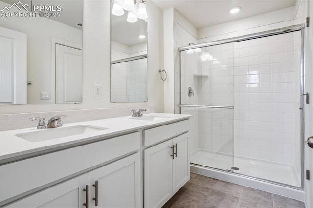 6745 Raven Ridge Ter, Colorado Springs, CO 80925 - bathroom featuring a sink, double vanity, a stall shower, and recessed lighting
