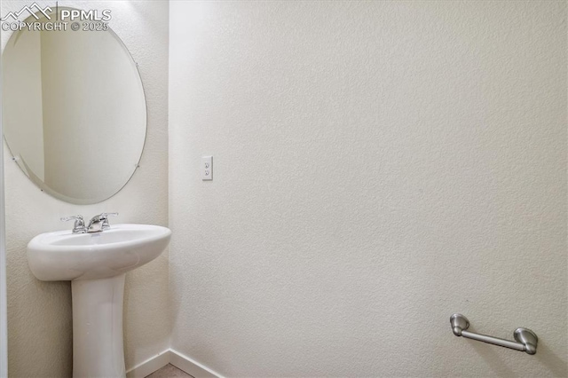 6745 Raven Ridge Ter, Colorado Springs, CO 80925 - bathroom with a sink and baseboards