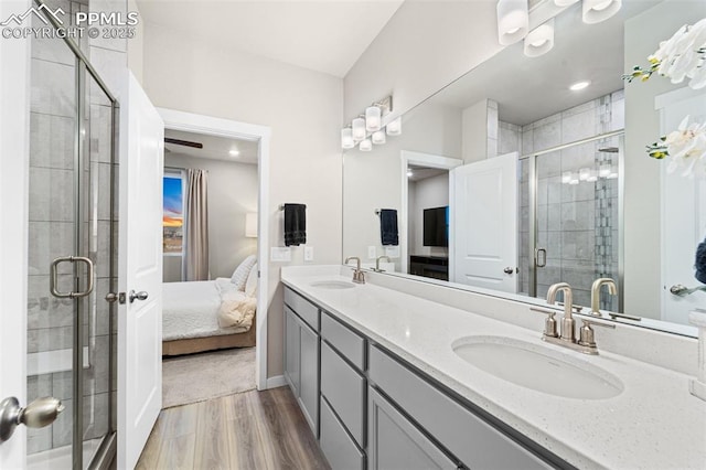 8093 Yellowleaf Pl, Colorado Springs, CO 80908 - ensuite bathroom with ensuite bath, wood finished floors, a shower stall, and a sink