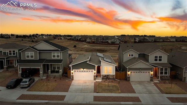 8093 Yellowleaf Pl, Colorado Springs, CO 80908 - view of front of home featuring stone siding, board and batten siding, driveway, and a residential view