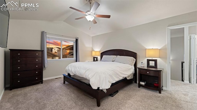 carpeted bedroom with vaulted ceiling, baseboards, and a ceiling fan