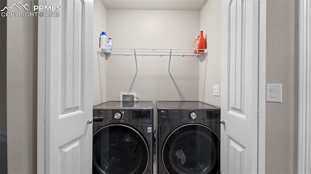 washroom featuring laundry area and washer and dryer