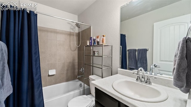 full bathroom with toilet, shower / tub combo with curtain, vanity, and a textured wall