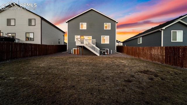 back of property with a fenced backyard