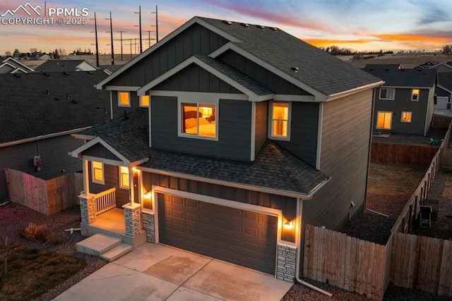 view of front of home featuring board and batten siding, roof with shingles, and an attached garage