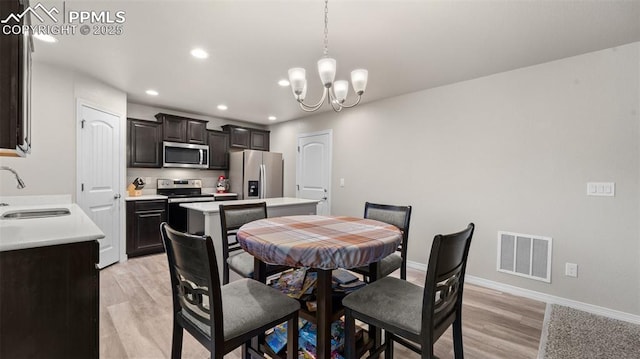 dining area with visible vents, baseboards, light wood-style floors, a chandelier, and recessed lighting