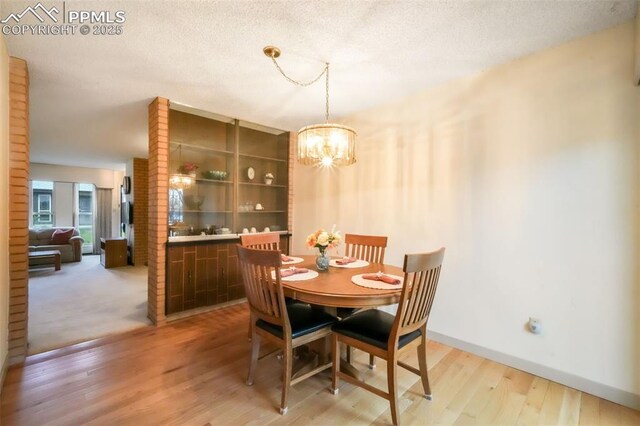 3314 Valley Hi Ave Unit B, Colorado Springs, CO 80910 - dining space with light wood-style flooring, a chandelier, and baseboards