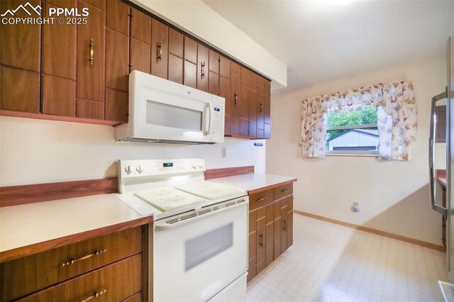 3314 Valley Hi Ave Unit B, Colorado Springs, CO 80910 - kitchen with white appliances, baseboards, brown cabinetry, light countertops, and light flooring