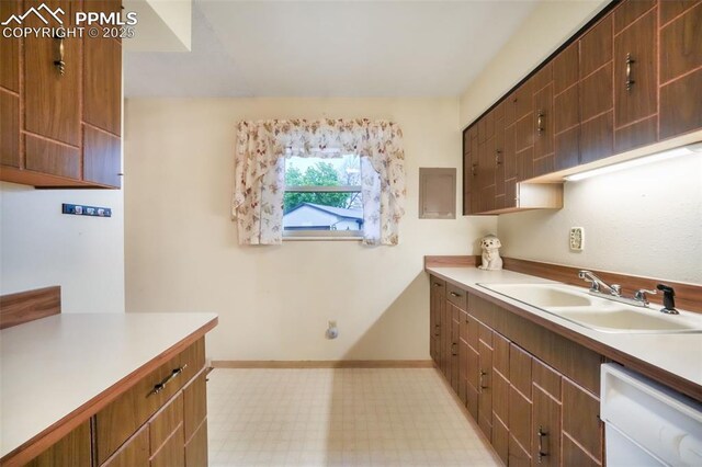 3314 Valley Hi Ave Unit B, Colorado Springs, CO 80910 - kitchen featuring dishwasher, a sink, light countertops, light flooring, and baseboards