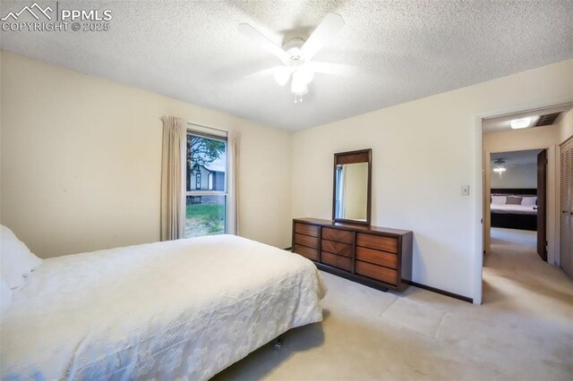 3314 Valley Hi Ave Unit B, Colorado Springs, CO 80910 - bedroom featuring light carpet, a textured ceiling, and a ceiling fan