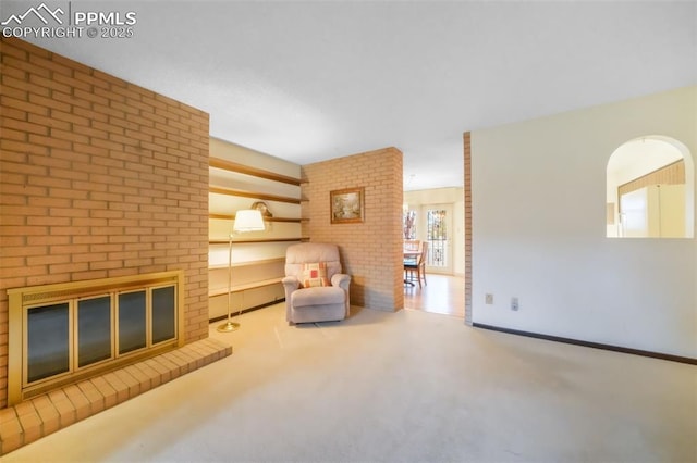 3314 Valley Hi Ave Unit B, Colorado Springs, CO 80910 - sitting room with carpet flooring, a brick fireplace, and brick wall