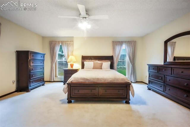 3314 Valley Hi Ave Unit B, Colorado Springs, CO 80910 - bedroom with light colored carpet, baseboards, a ceiling fan, and a textured ceiling