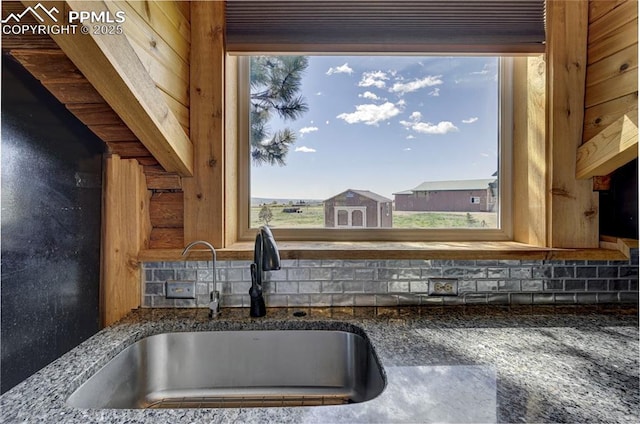 3645 Doolittle Rd, Monument, CO 80132 - kitchen view of a sink, dark stone countertops, and decorative backsplash