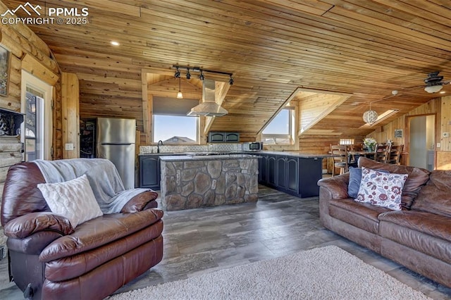 3645 Doolittle Rd, Monument, CO 80132 - living area featuring lofted ceiling, wooden ceiling, wood walls, and a ceiling fan