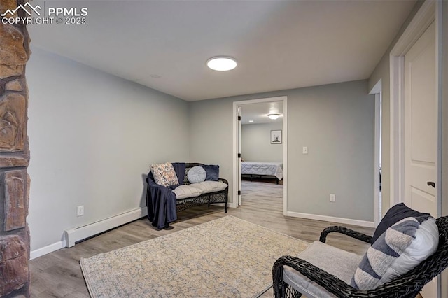 3645 Doolittle Rd, Monument, CO 80132 - living area featuring baseboard heating, wood finished floors, and baseboards