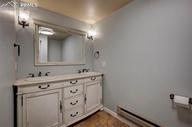 3645 Doolittle Rd, Monument, CO 80132 - bathroom featuring double vanity, baseboard heating, and baseboards