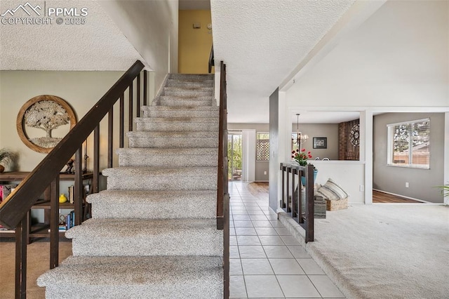 stairs with a textured ceiling, tile patterned floors, carpet floors, and a chandelier