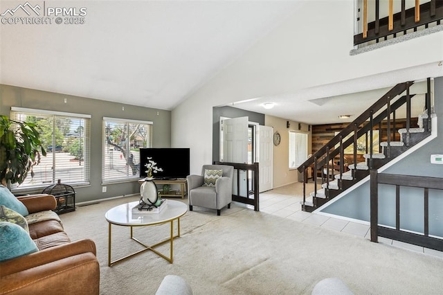 carpeted living room with stairs, baseboards, tile patterned flooring, and high vaulted ceiling