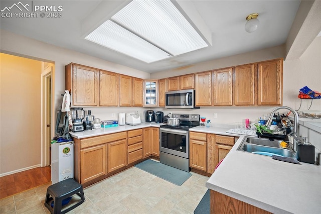 7136 Purple Thistle Ct, Colorado Springs, CO 80922 - kitchen featuring appliances with stainless steel finishes, light countertops, and a sink