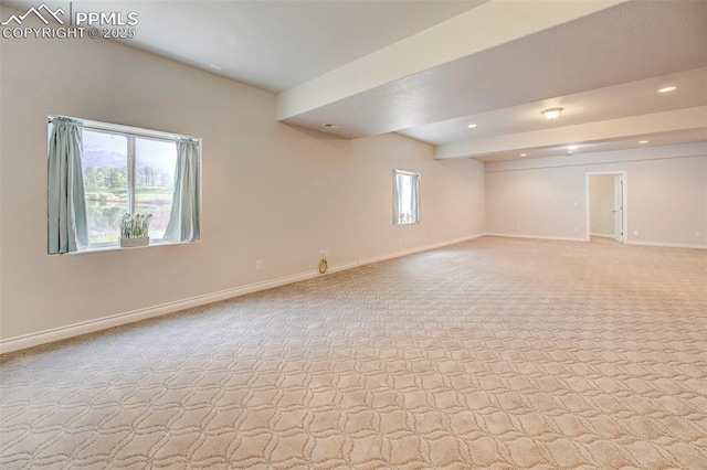 basement featuring light carpet, baseboards, and recessed lighting