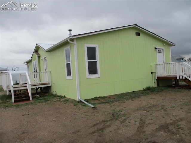 view of side of property featuring a deck