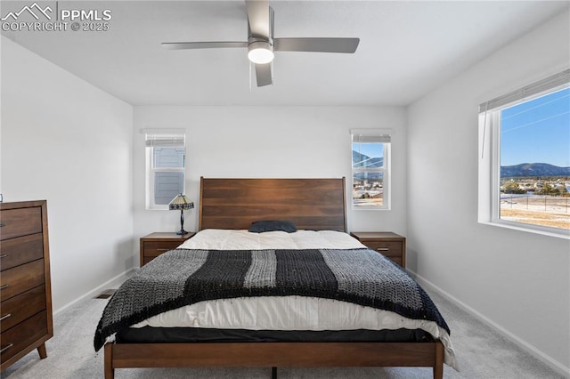 16422 Mountain Flax Dr, Monument, CO 80132 - carpeted bedroom featuring multiple windows, ceiling fan, and a mountain view