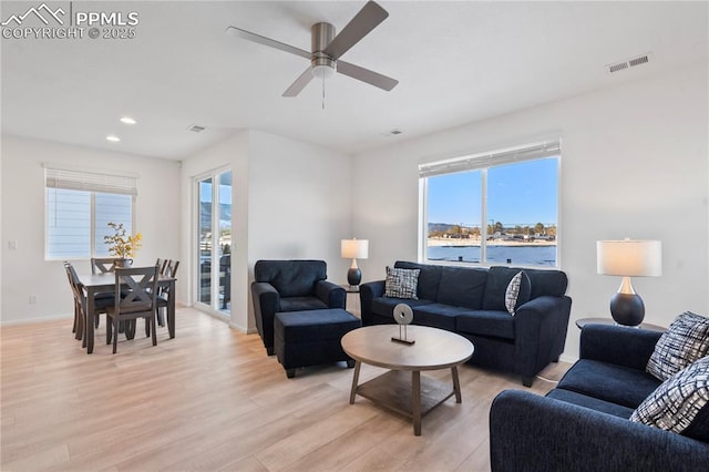 16422 Mountain Flax Dr, Monument, CO 80132 - living room featuring a ceiling fan, light wood finished floors, recessed lighting, and a water view