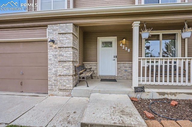 4258 Grassy Ct, Colorado Springs, CO 80916 - property entrance featuring covered porch and stone siding