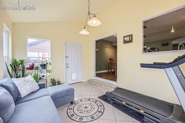 4258 Grassy Ct, Colorado Springs, CO 80916 - living area with lofted ceiling, light tile patterned floors, and baseboards