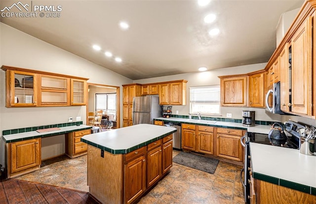26985 Flower Cir, Simla, CO 80835 - kitchen with appliances with stainless steel finishes, lofted ceiling, recessed lighting, glass insert cabinets, and a sink