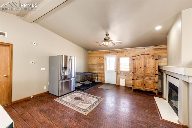 26985 Flower Cir, Simla, CO 80835 - living area with a ceiling fan, dark wood finished floors, wood walls, baseboards, and a premium fireplace