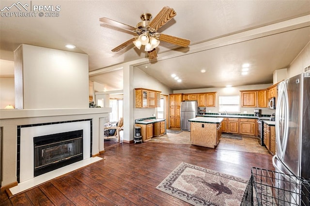26985 Flower Cir, Simla, CO 80835 - kitchen featuring appliances with stainless steel finishes, a kitchen island, a sink, a ceiling fan, and hardwood / wood-style flooring