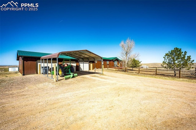 26985 Flower Cir, Simla, CO 80835 - view of yard with a carport, dirt driveway, and an outbuilding