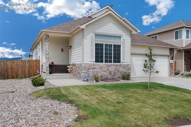 6244 Roundup Butte St, Colorado Springs, CO 80925 - view of front of home with a garage, stone siding, concrete driveway, and roof with shingles