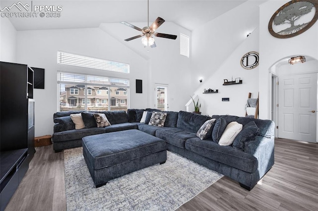6244 Roundup Butte St, Colorado Springs, CO 80925 - living room with high vaulted ceiling, a ceiling fan, wood finished floors, and arched walkways