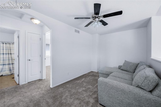 6244 Roundup Butte St, Colorado Springs, CO 80925 - carpeted living area with arched walkways, ceiling fan, and baseboards