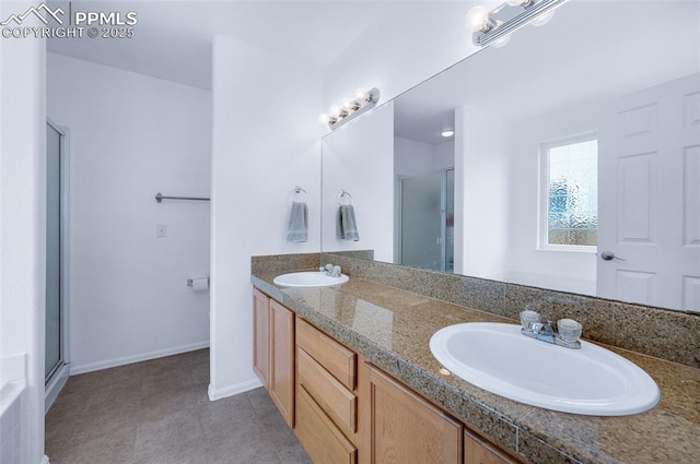 6244 Roundup Butte St, Colorado Springs, CO 80925 - full bathroom featuring a stall shower, double vanity, and baseboards