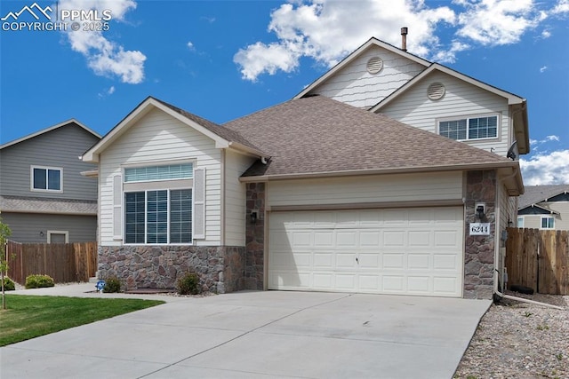 6244 Roundup Butte St, Colorado Springs, CO 80925 - view of front of house featuring stone siding, a garage, driveway, and roof with shingles