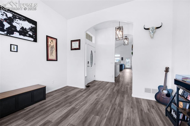 6244 Roundup Butte St, Colorado Springs, CO 80925 - corridor with arched walkways, dark wood-style floors, and baseboards