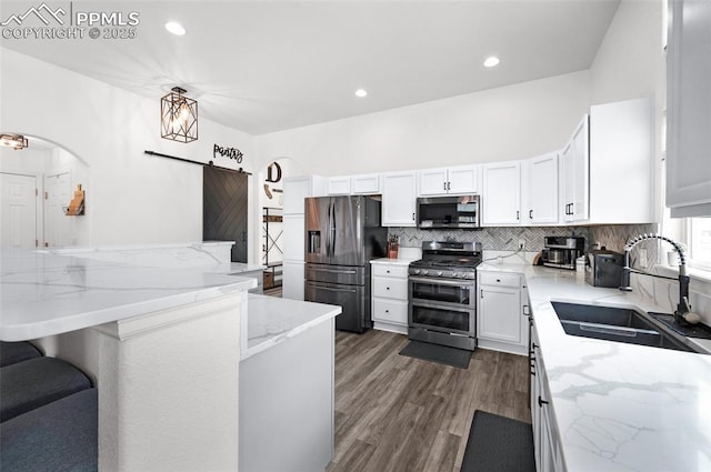 6244 Roundup Butte St, Colorado Springs, CO 80925 - kitchen with stainless steel appliances, a sink, decorative backsplash, light stone counters, and recessed lighting