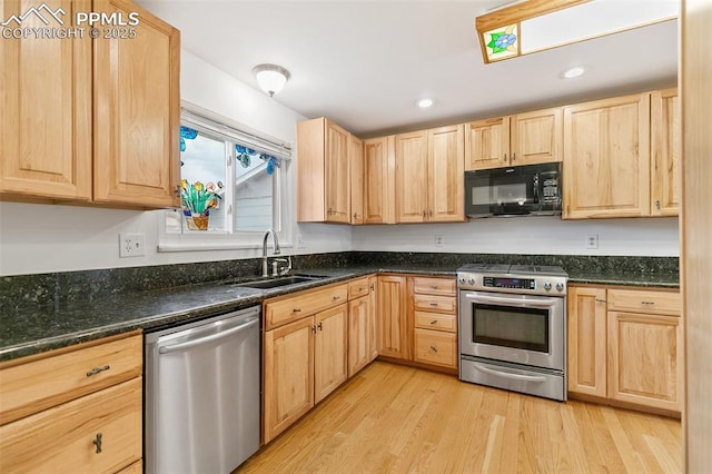 kitchen with stainless steel appliances, light brown cabinets, a sink, light wood-style flooring, and recessed lighting