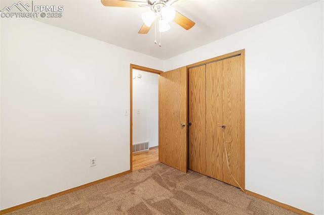 unfurnished bedroom with light carpet, baseboards, a closet, and ceiling fan