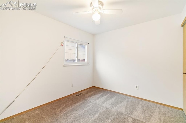 carpeted empty room with ceiling fan and baseboards