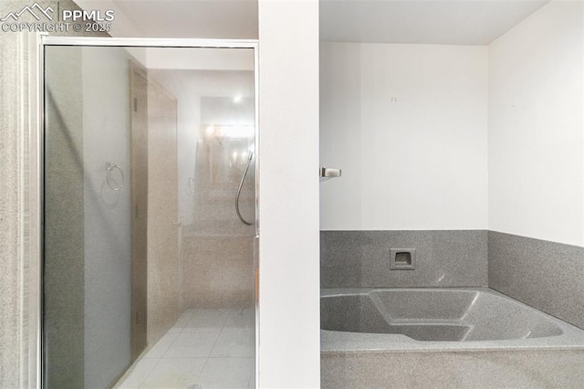 full bathroom with a bath, a shower stall, and tile patterned floors