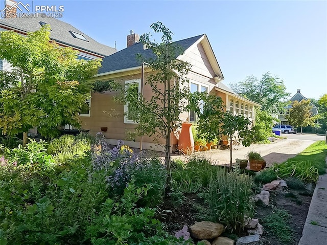 726 N Weber St, Colorado Springs, CO 80903 - view of side of property featuring a chimney and roof with shingles