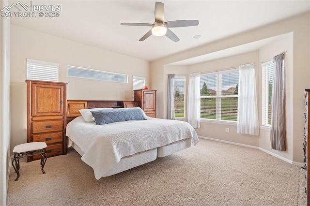 bedroom featuring light carpet, baseboards, and ceiling fan