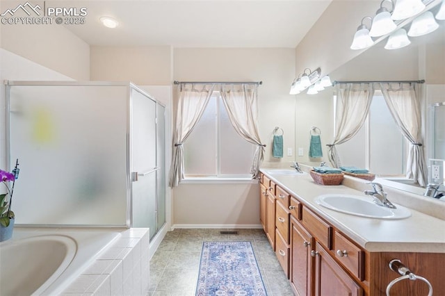 bathroom featuring double vanity, a stall shower, a garden tub, a chandelier, and baseboards