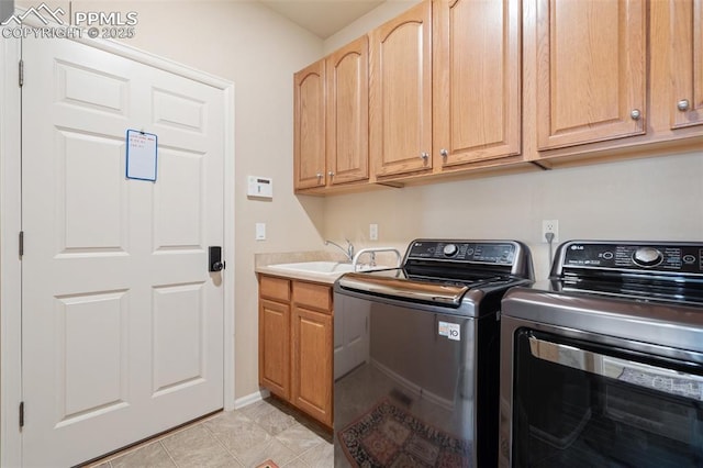 laundry room featuring separate washer and dryer, cabinet space, and light tile patterned flooring
