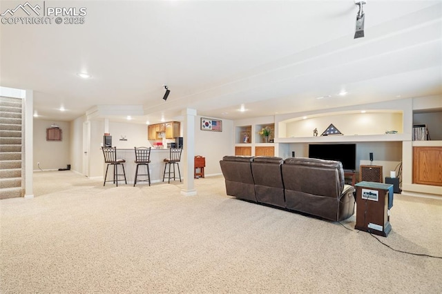 living room featuring bar area, carpet, stairs, baseboards, and recessed lighting